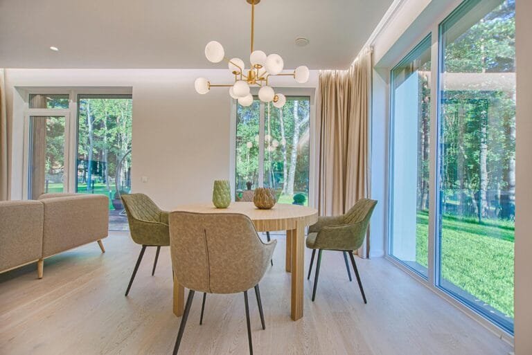 Elegant dining room featuring modern furniture and large windows for natural light.