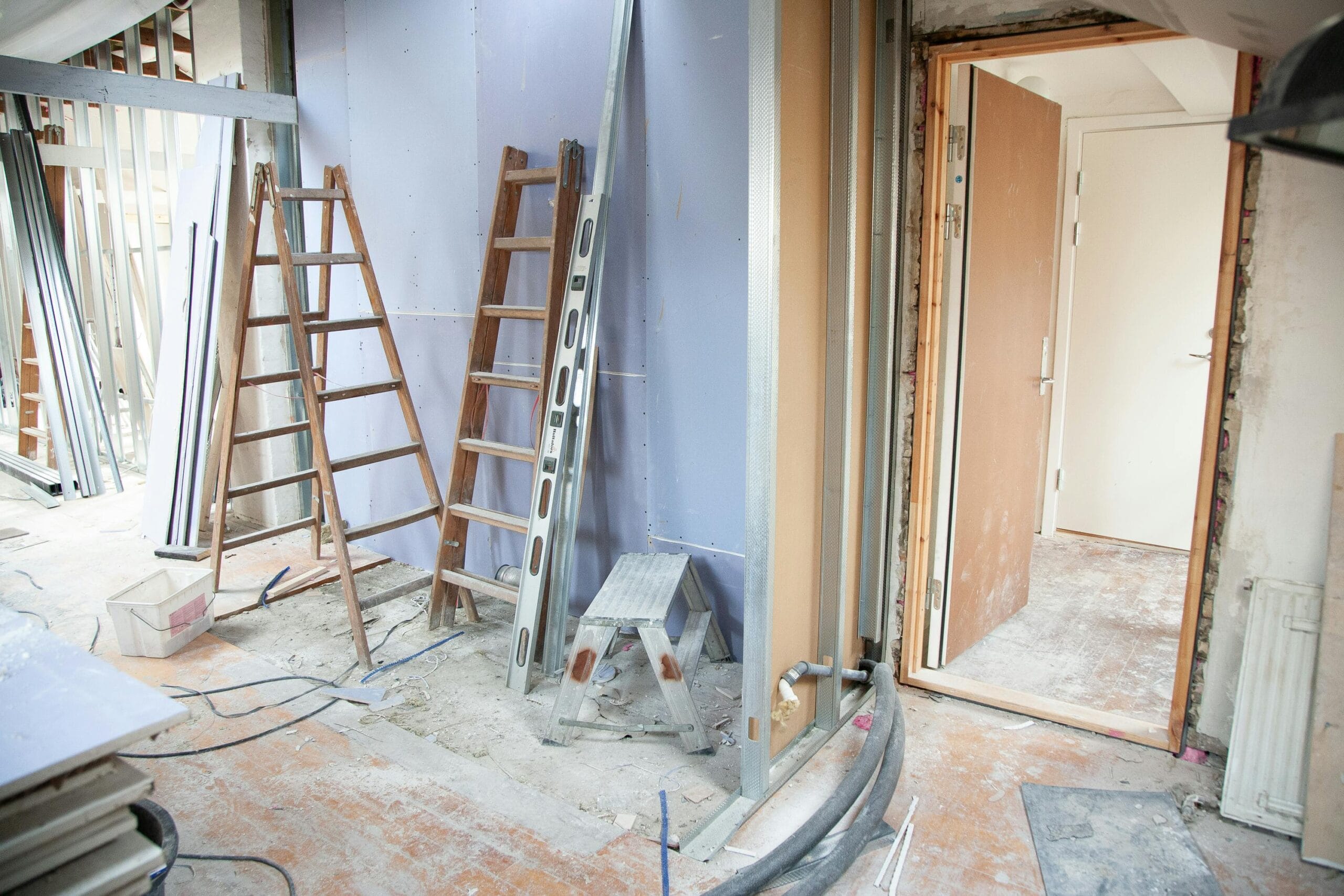 Renovations That Deliver the Best ROI for Rental Properties Construction site featuring ladders and tools in a home renovation setting.